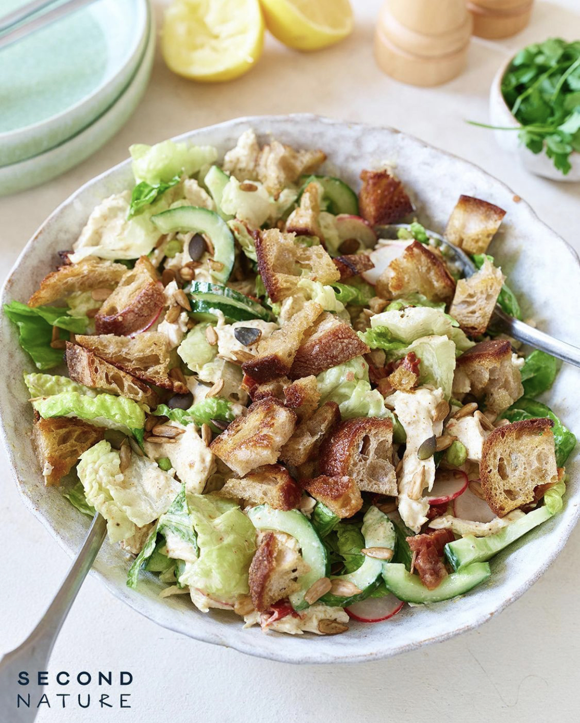 A chicken salad with lettuce, croutons and a coronation dressing