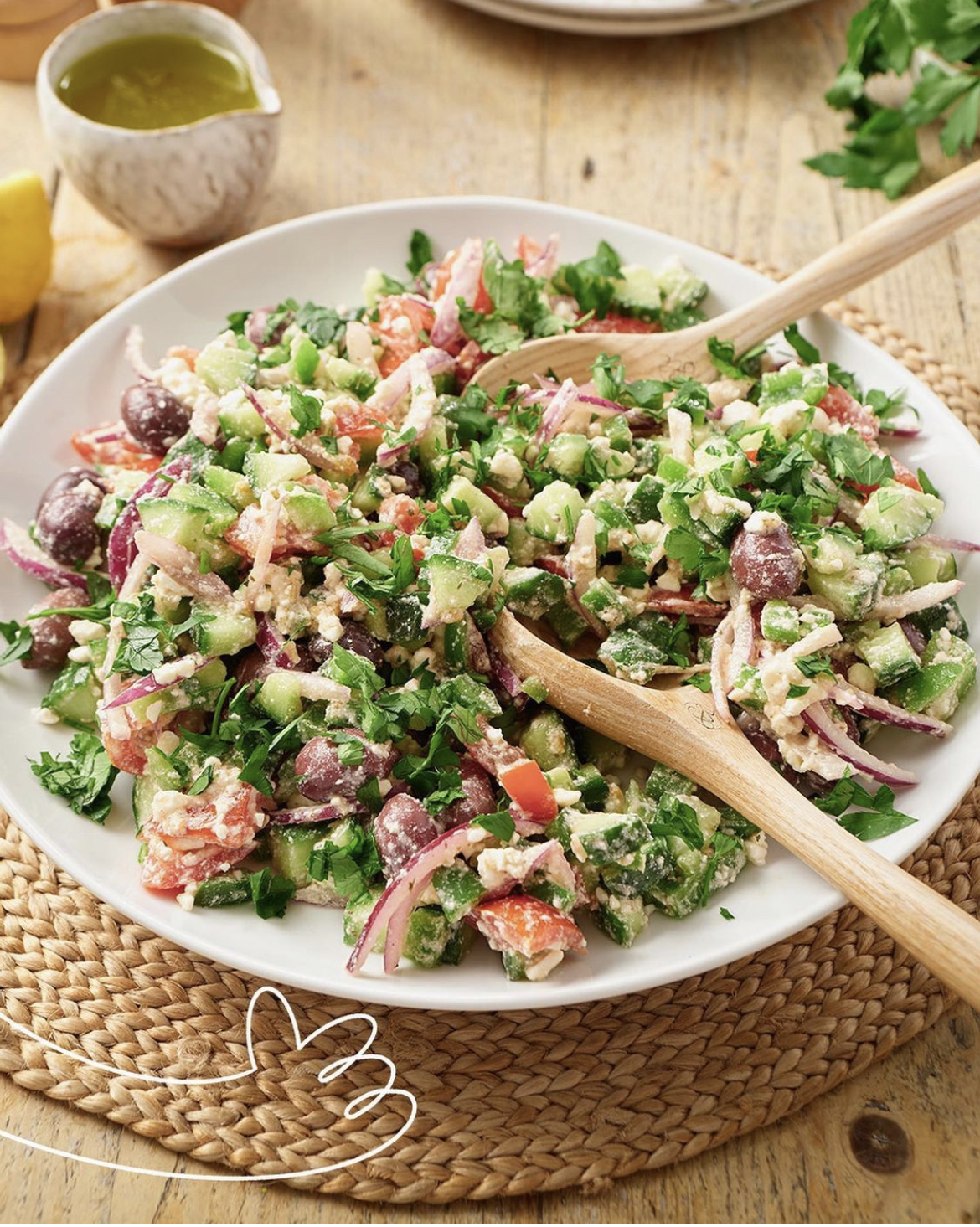 A large bowl of Greek salad with feta, olives, cucumber