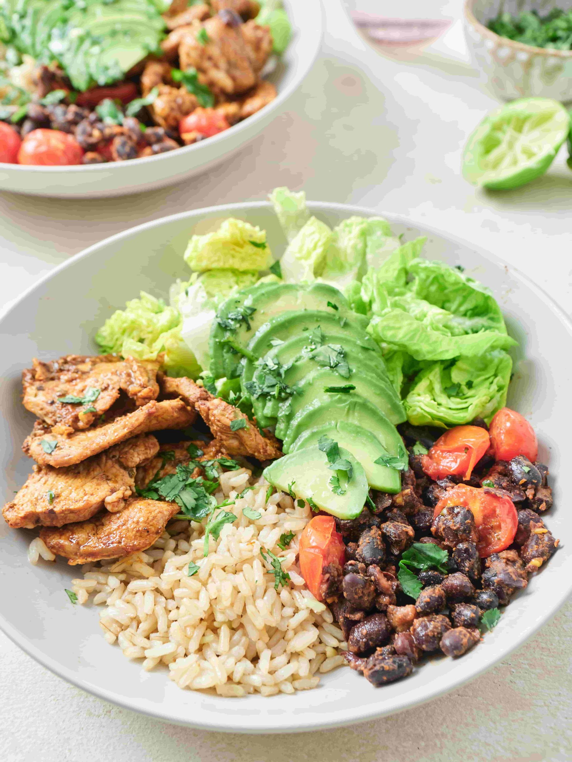 Second Nature's Mexican pork bowl recipe image, with pork, avocado, beans, and brown rice.